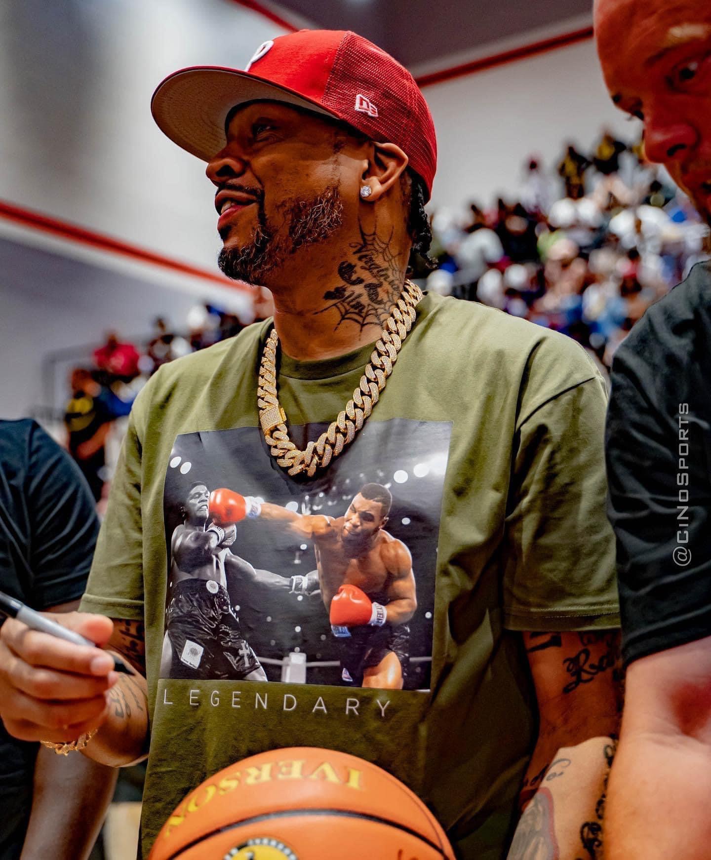 Basketball legend courtside at a packed gym