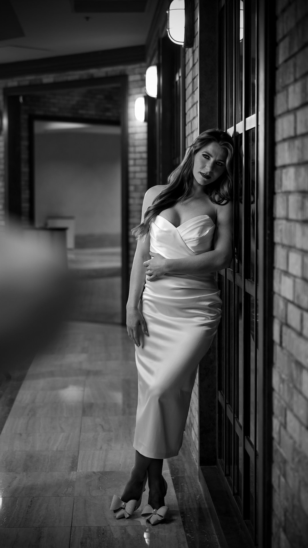 Black and white fashion portrait of a woman in a satin gown