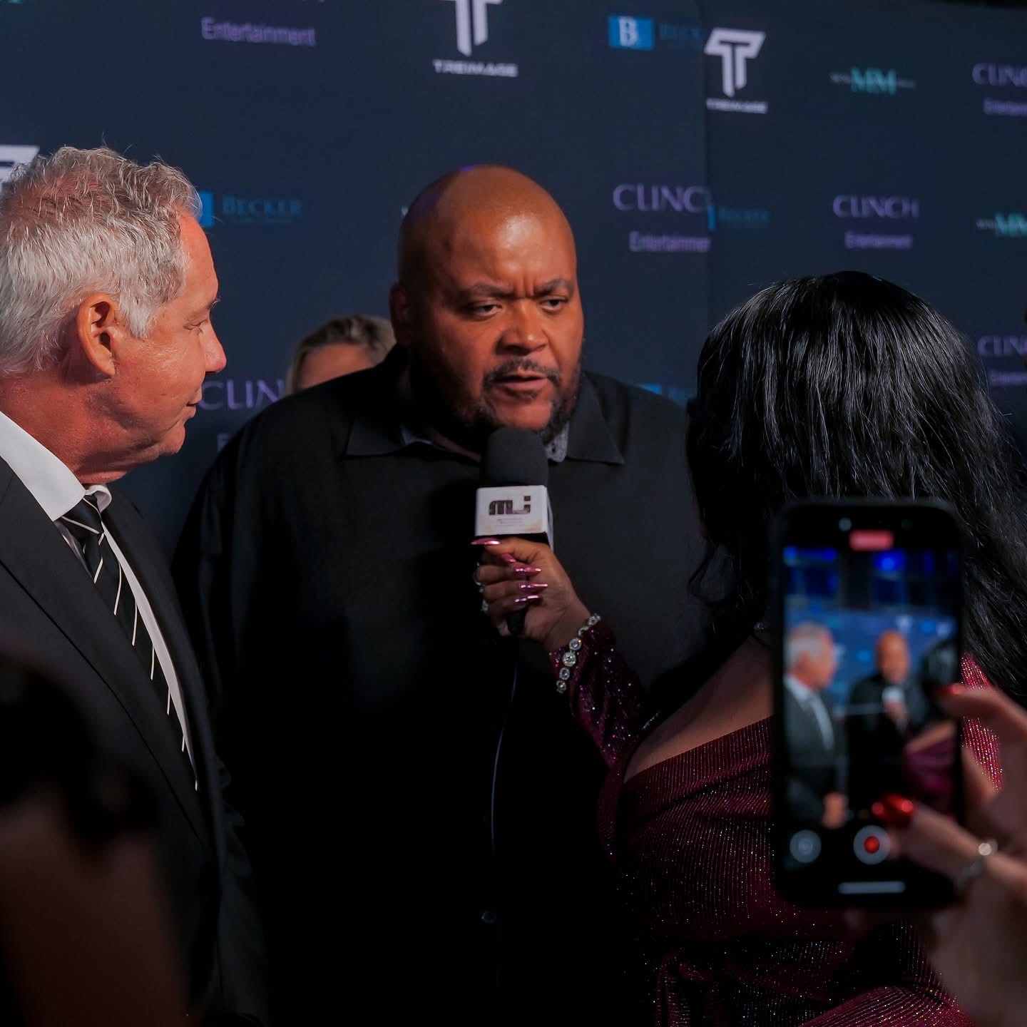 Red carpet interview with press microphone and photographers