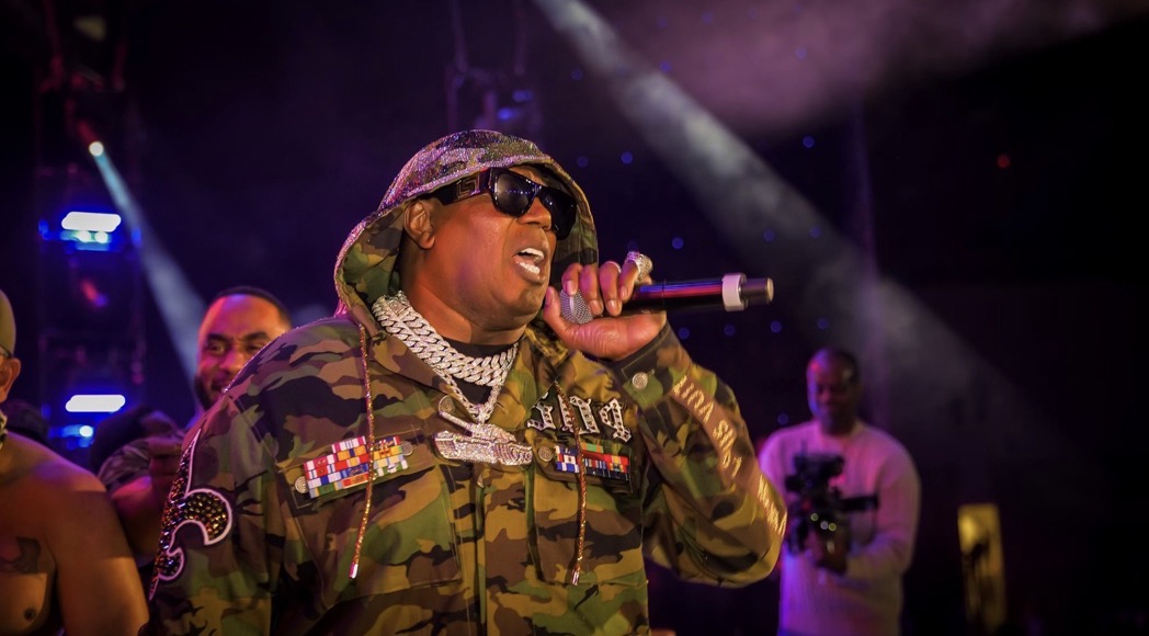Master P performing live on stage under stage haze and spotlights