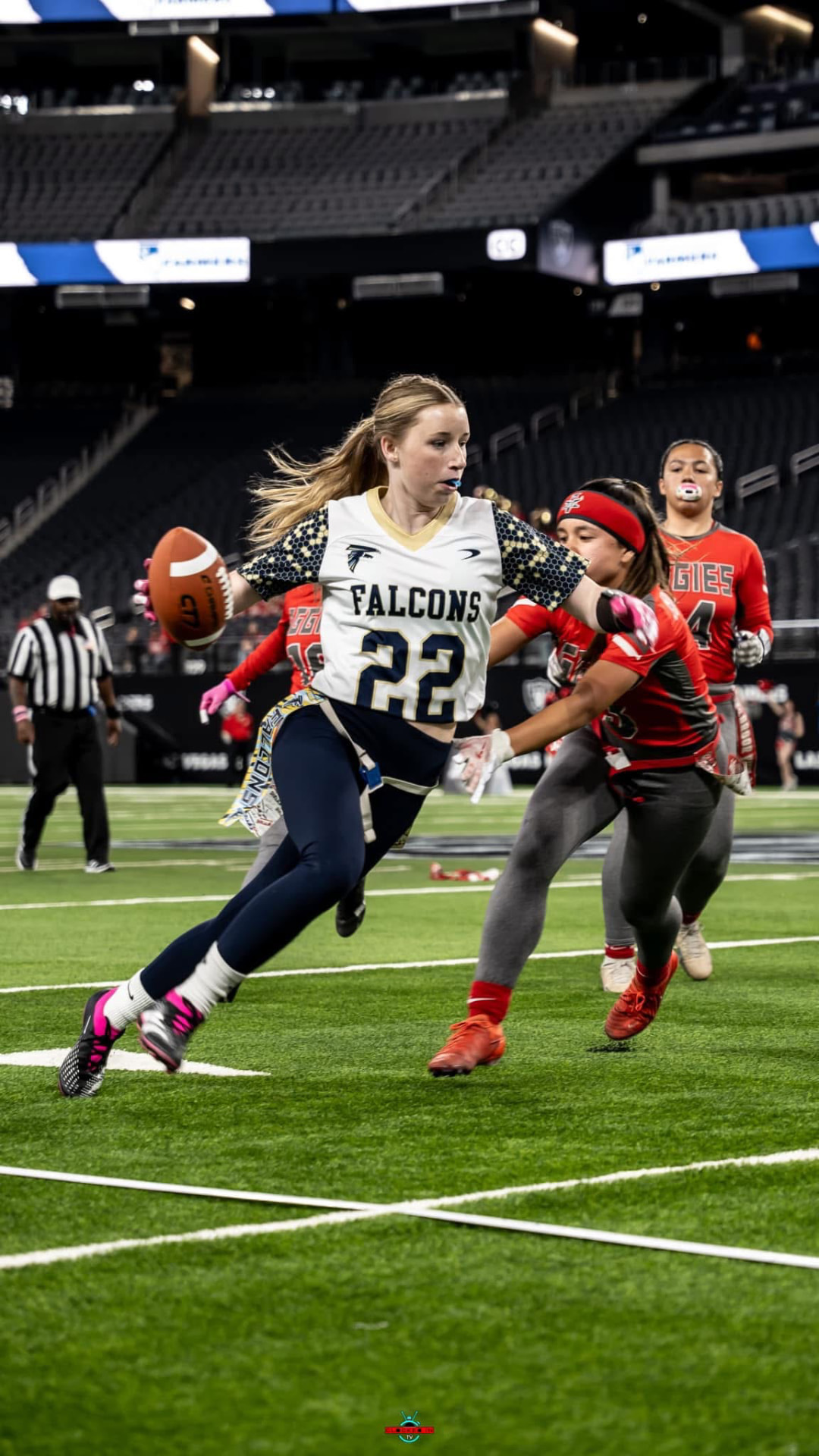 Flag football player breaking away with the ball in a stadium