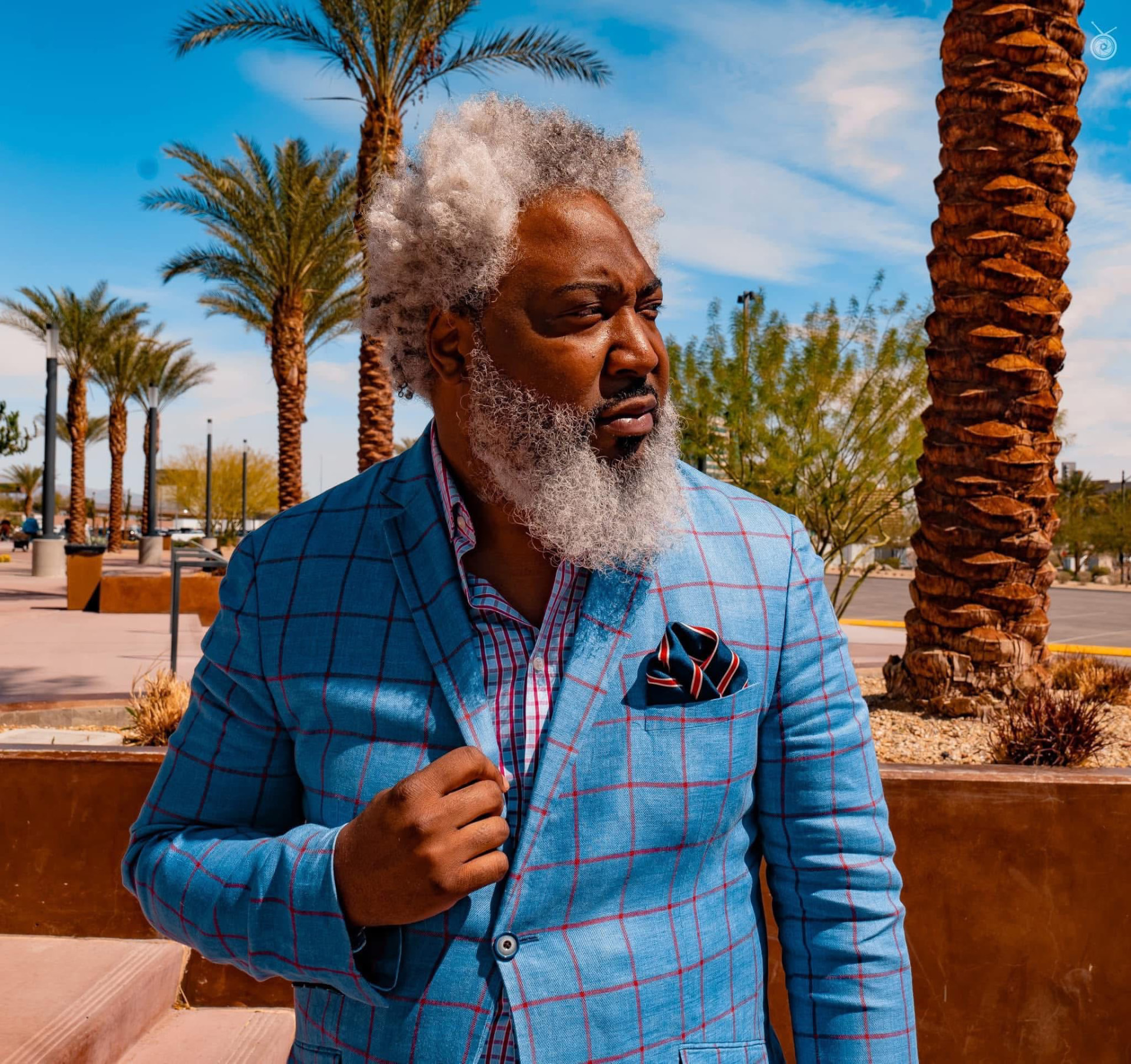 Outdoor portrait of a man in a blue windowpane blazer