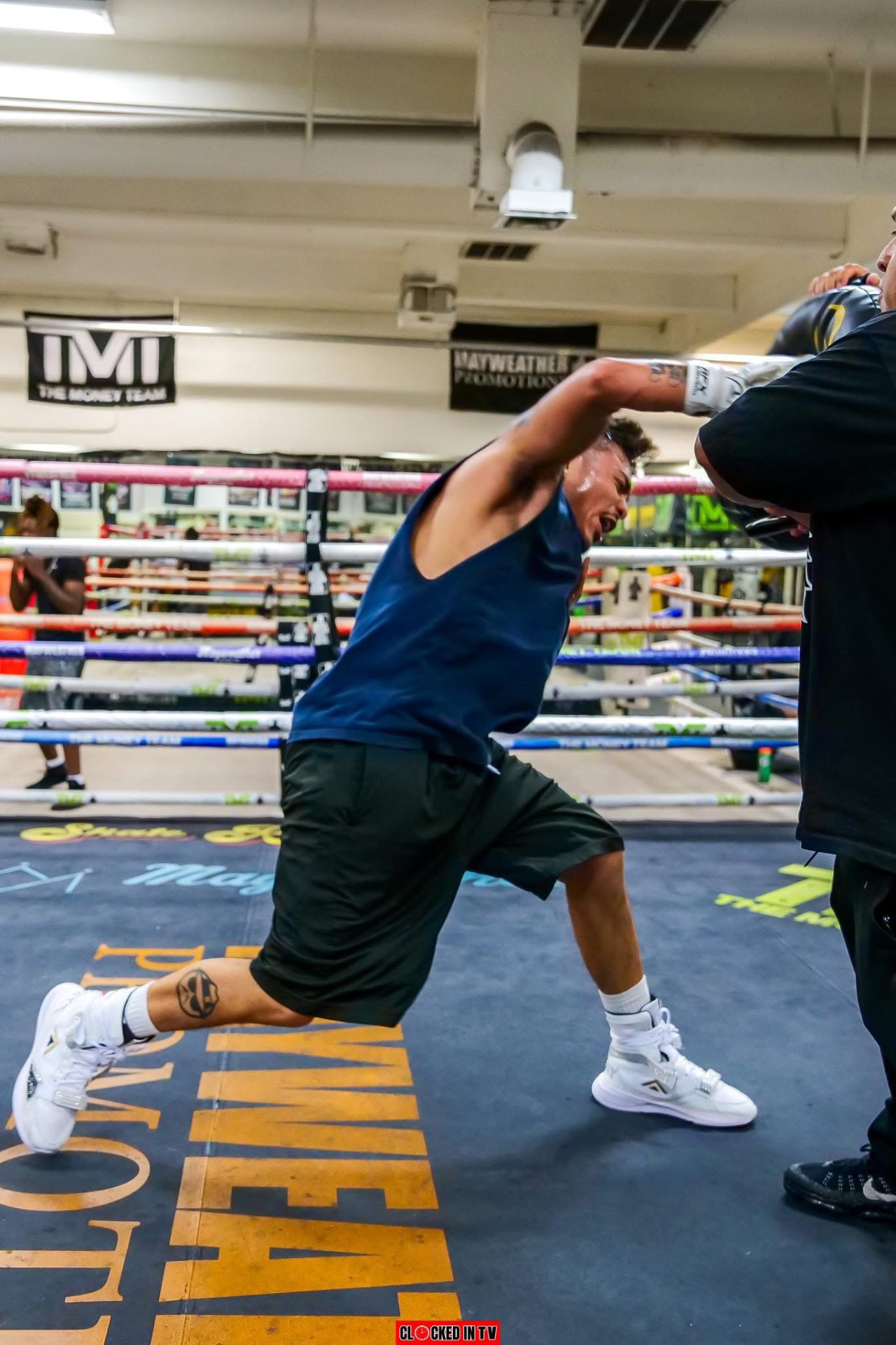 Boxer throwing a straight right into the mitts during training