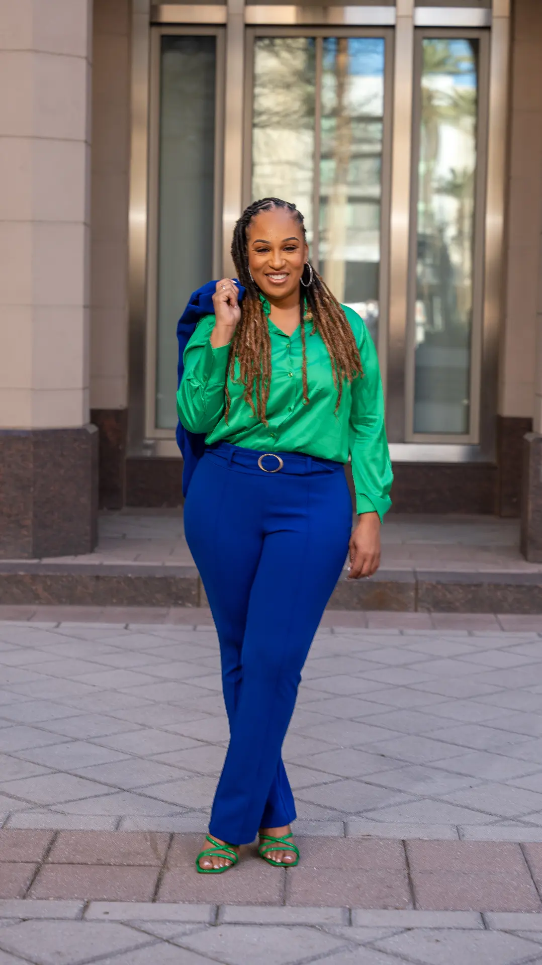 Full-length portrait of a woman in a green blouse and blue suit