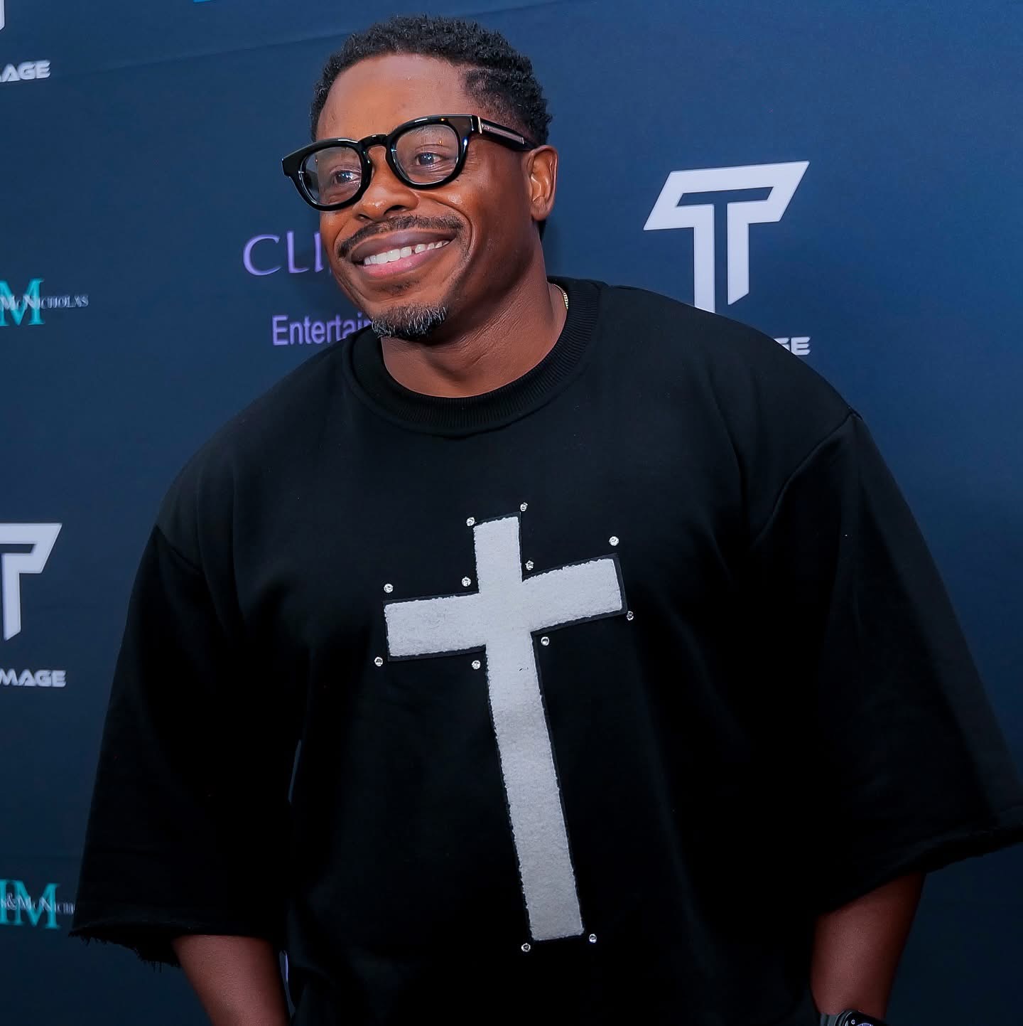 Guest smiling on the step-and-repeat at an awards event
