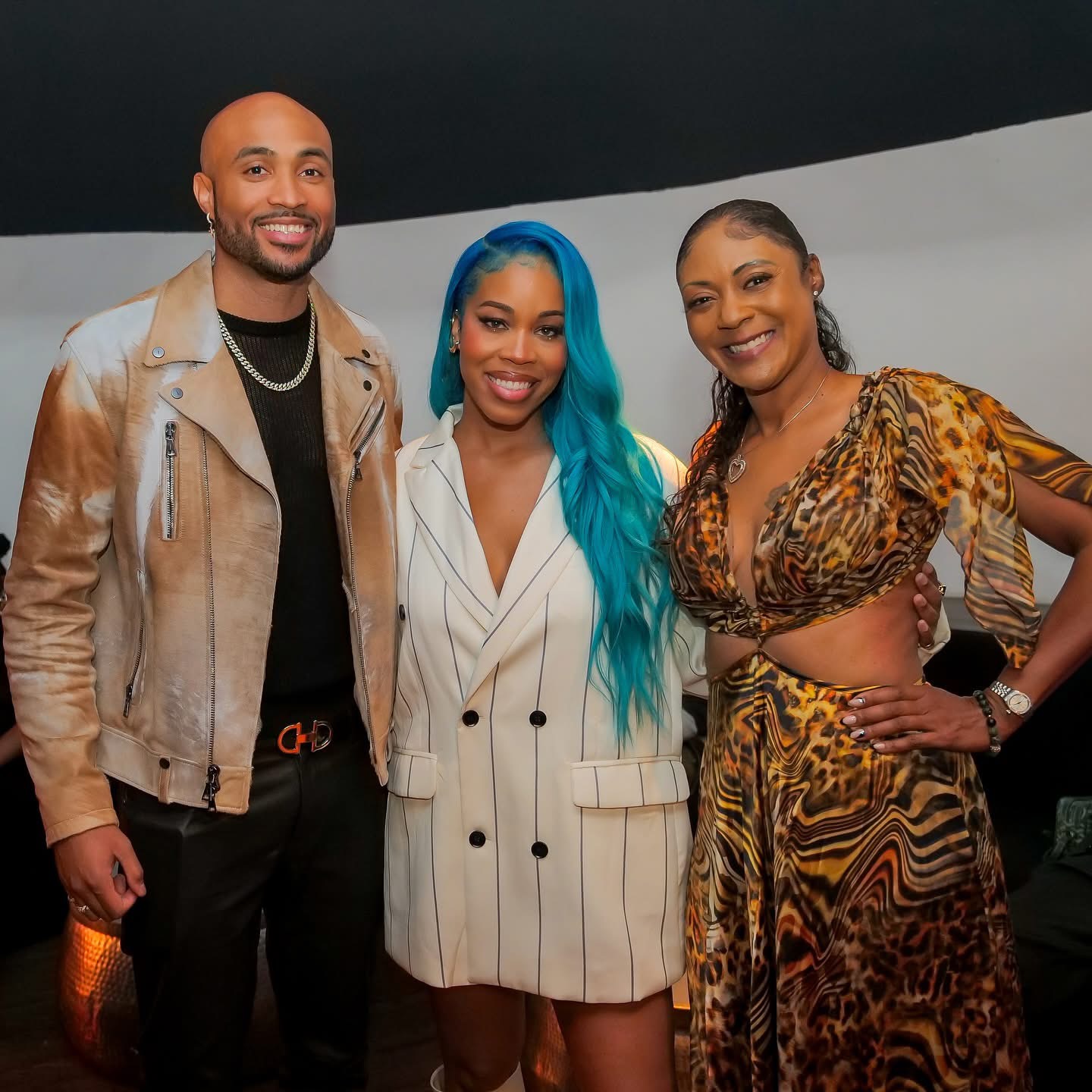 Three guests posing together at an entertainment industry event